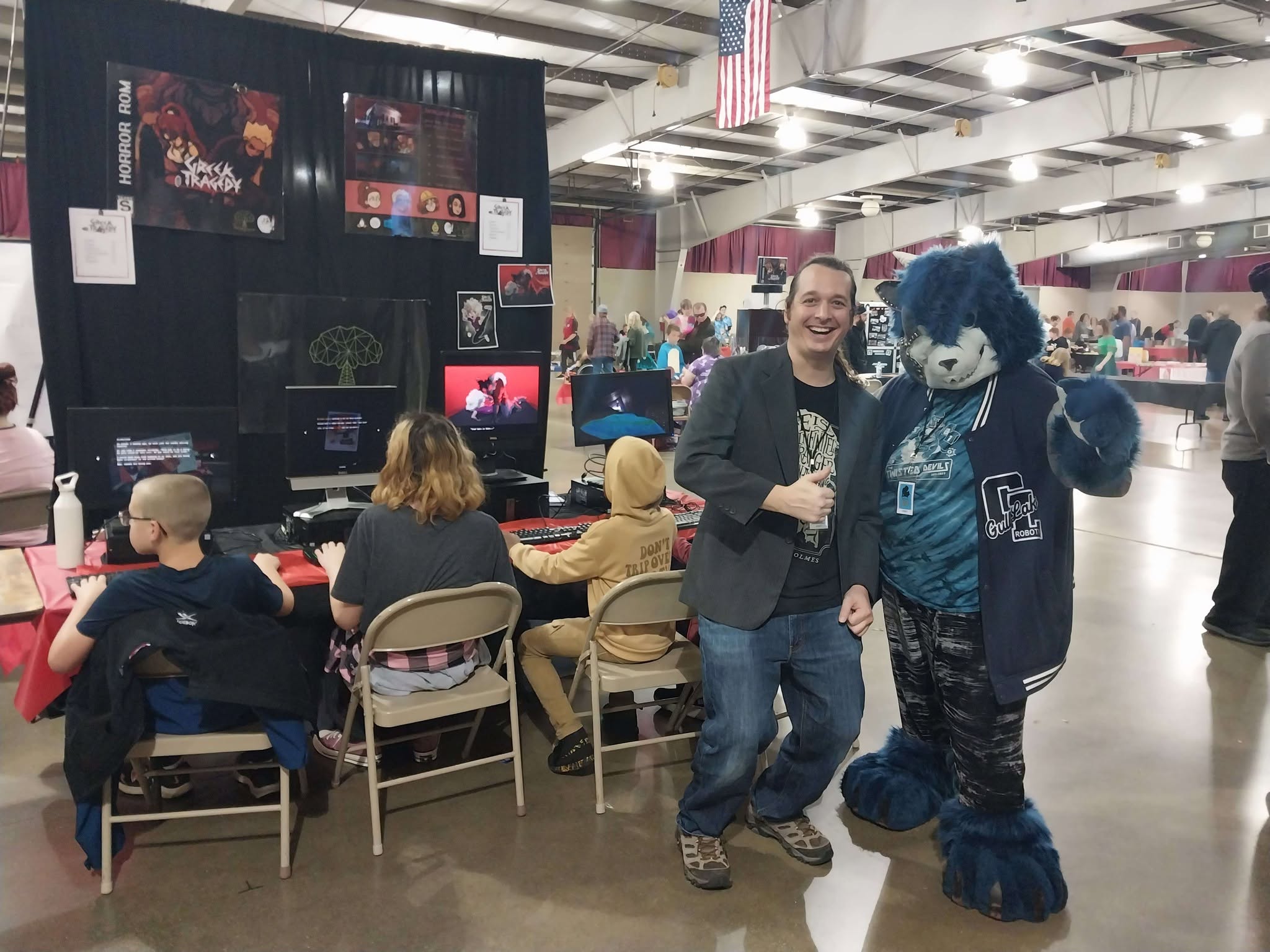 Prairieville Games booth at Geek Fest 2023 with attendees playing games and a costumed guest